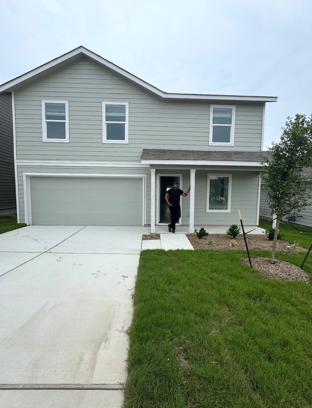Russell standing in front of his new house